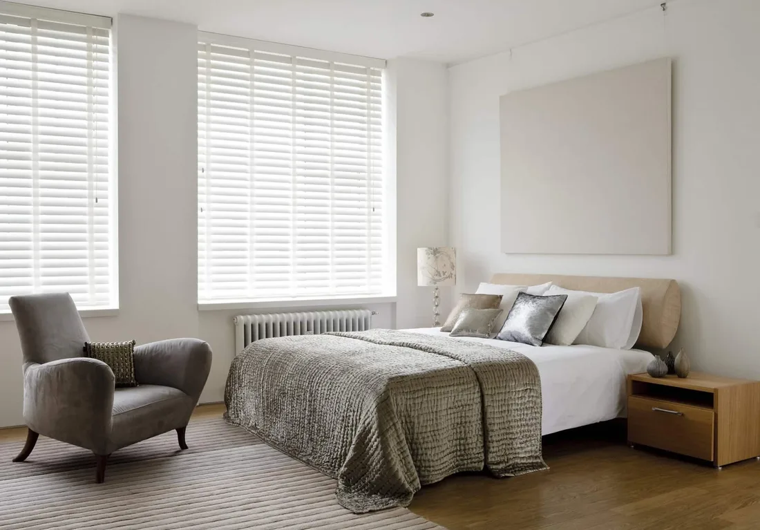 White wooden blinds in a bright bedroom