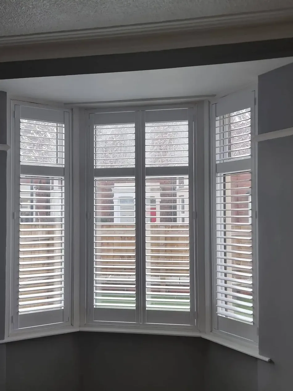 Tier-on-tier shutters in a period bay window